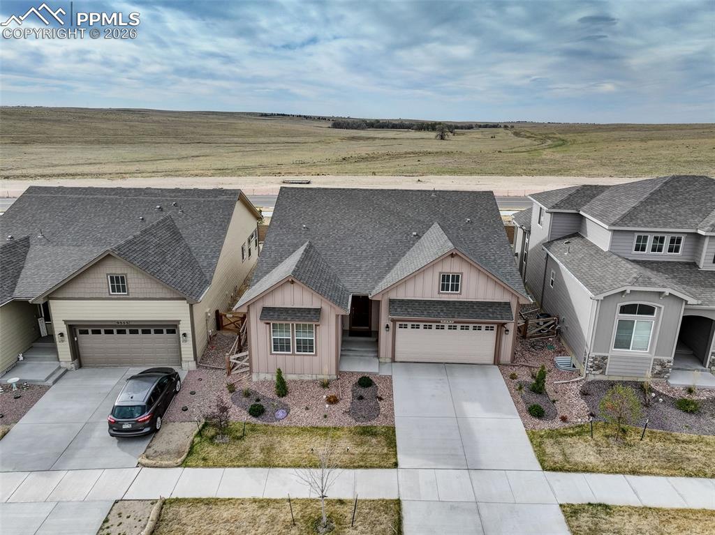 Image 43 of 44: Single-story residence featuring a neutral-toned exterior with board and ba