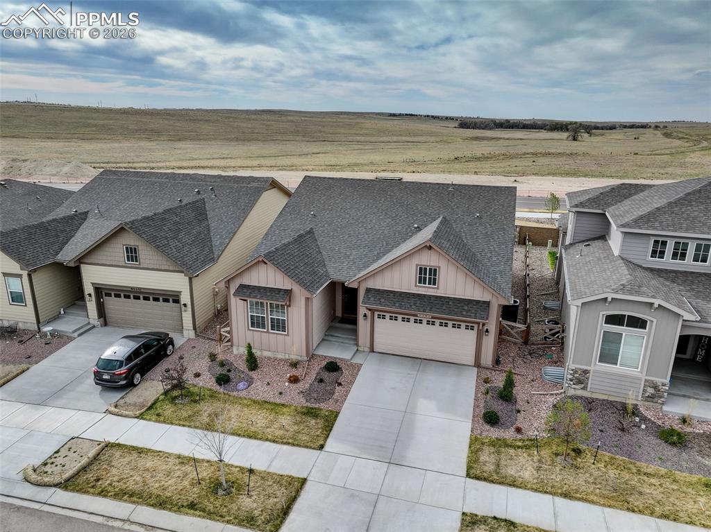 Image 44 of 44: Ranch-style residence featuring a two-car garage with a concrete driveway a