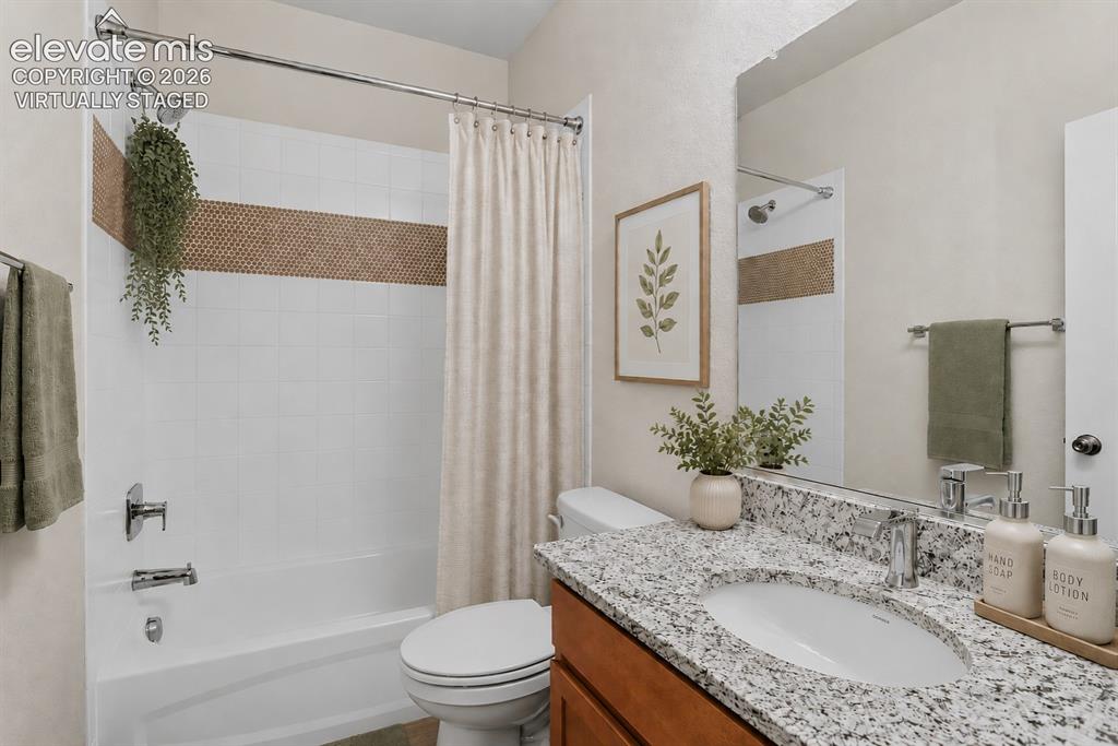 Image 5 of 49: Full bathroom featuring a white tub/shower combination with a mosaic tile a