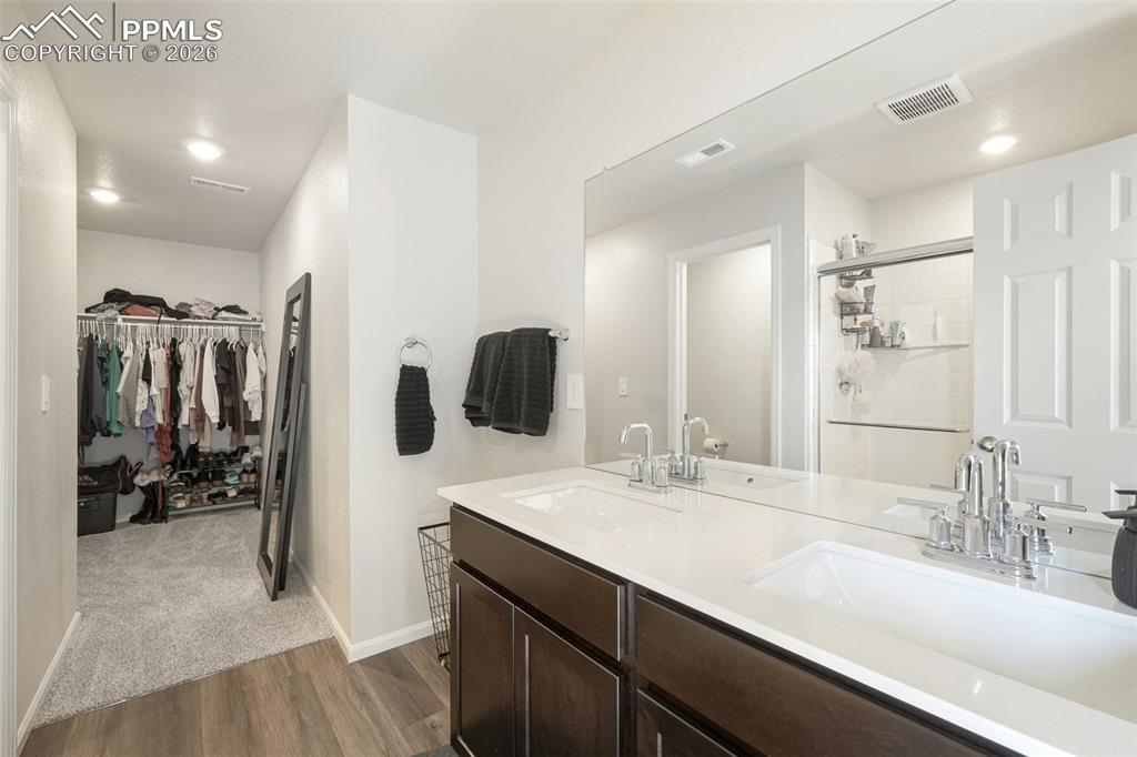 Image 26 of 34: primary bathroom and walk-in closet