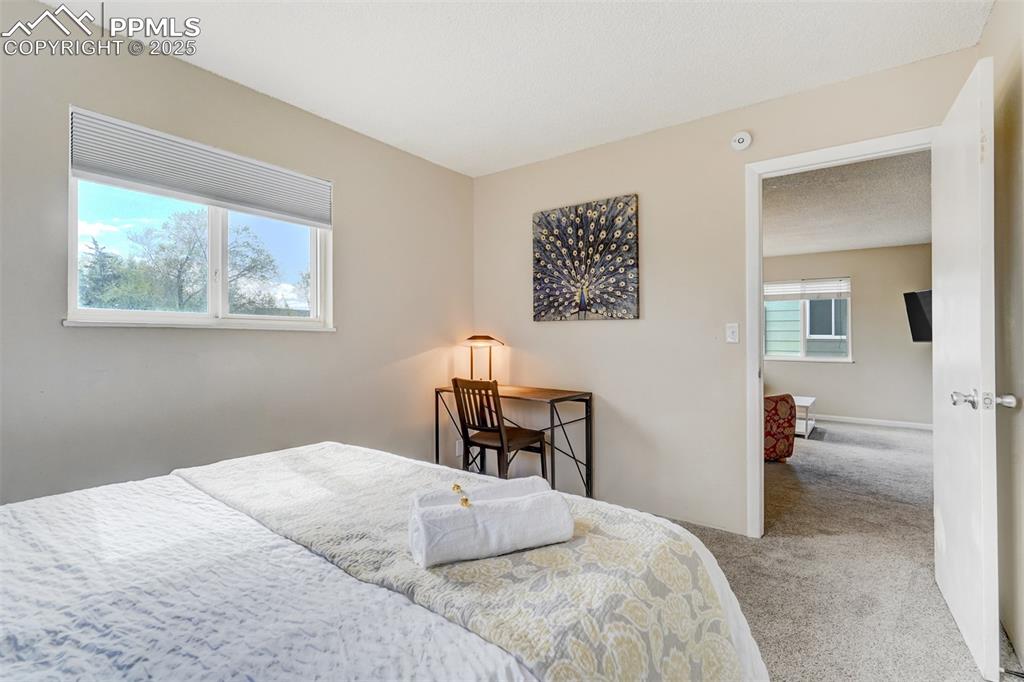 Image 11 of 25: Bedroom with carpet floors