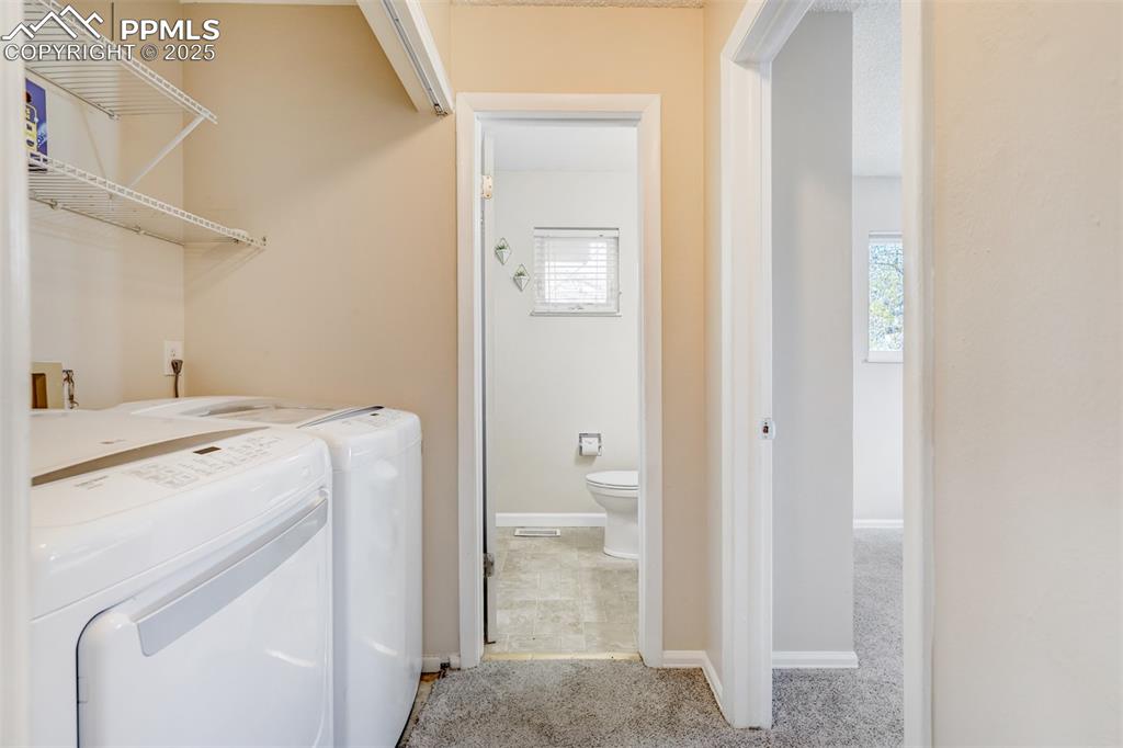 Image 13 of 25: Washroom featuring baseboards and separate washer and dryer