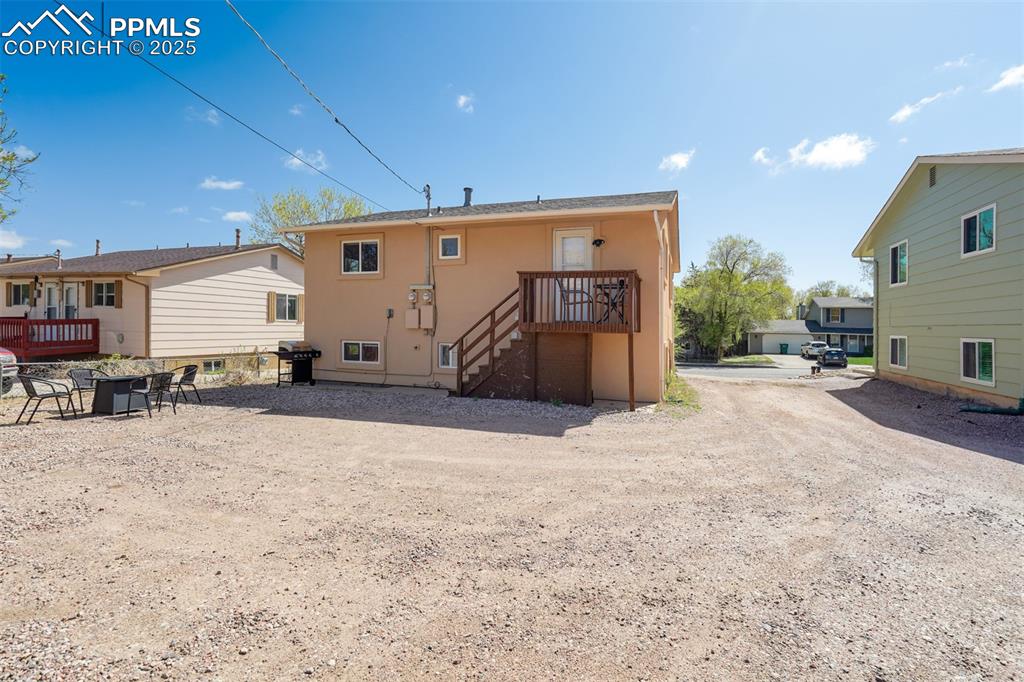 Image 16 of 25: Back of house with a patio, stucco siding, a deck, and stairway