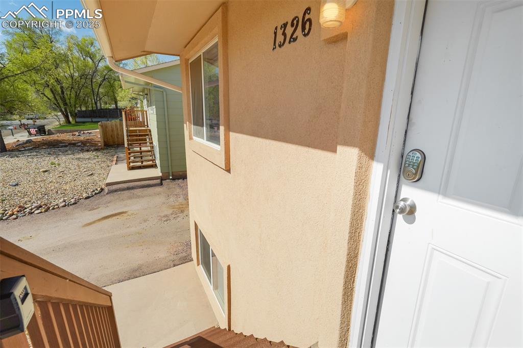 Image 4 of 25: View of exterior entry with stucco siding