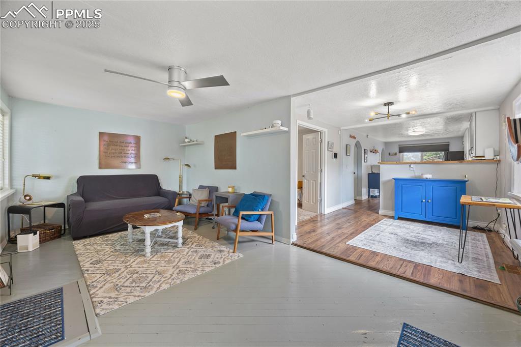 Image 10 of 36: Living room with hardwood / wood-style flooring, ceiling fan, and baseboard