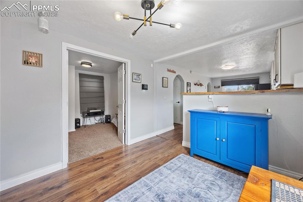 Image 16 of 36: Bathroom featuring a notable chandelier, baseboards, a textured ceiling, an