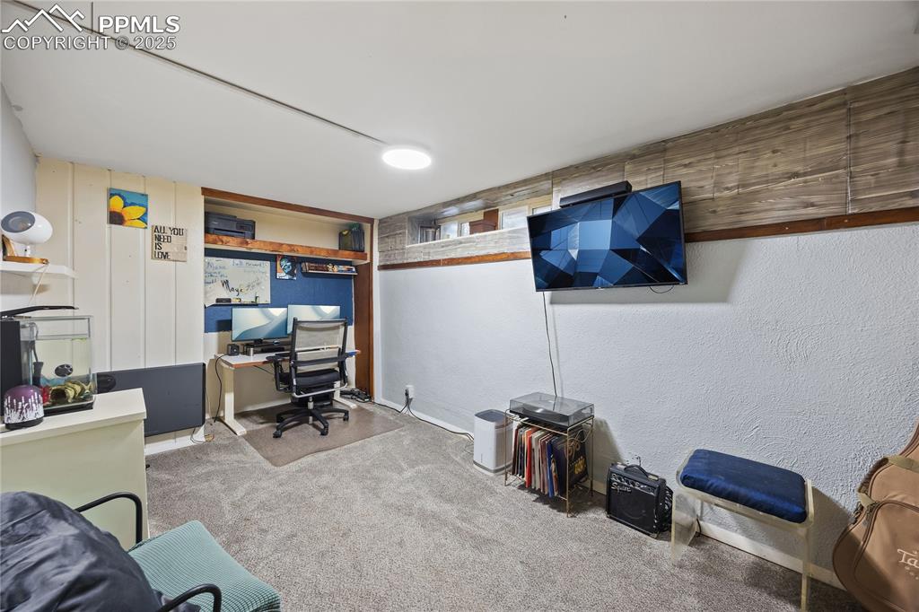 Image 23 of 36: Carpeted office space with a textured wall