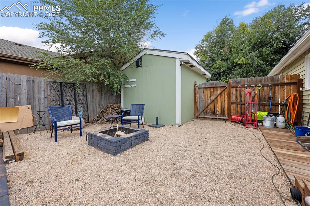 Image 35 of 36: View of patio / terrace with a fire pit, a gate, and fence