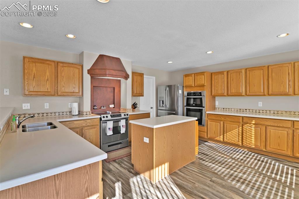 Image 13 of 50: Kitchen featuring recessed lighting, a kitchen island, stainless steel appl