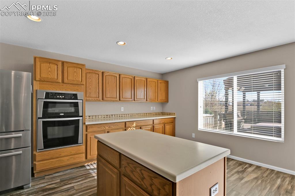 Image 16 of 50: Kitchen with appliances with stainless steel finishes, recessed lighting, d
