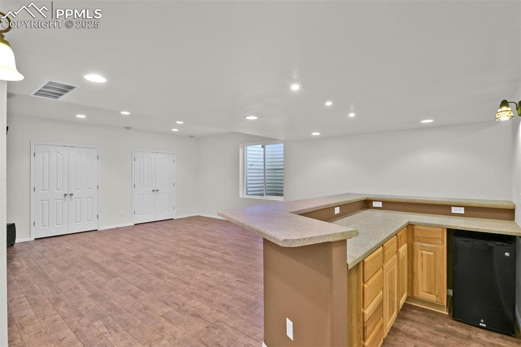 Image 35 of 50: Living Room in Basement with Bar