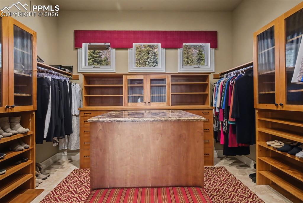 Image 29 of 50: Primary bedroom walk-in closet