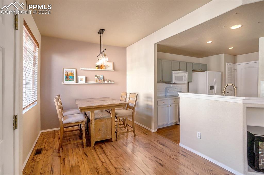 Image 9 of 26: Dining area with newer light fixture. Luxury Vinyl flooring