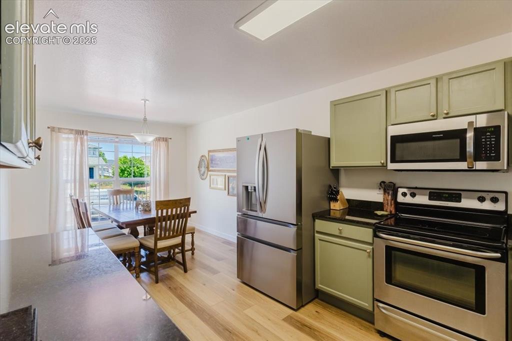 Image 3 of 38: granite countertops with dining area nook