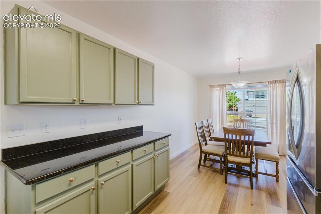 Image 4 of 38: granite countertops with dining area nook