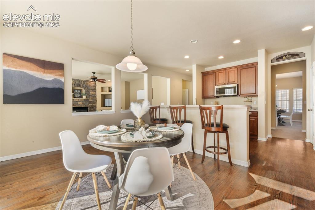 Image 14 of 50: Hardwood-finish flooring, recessed lighting, kitchen with rich wood cabinet