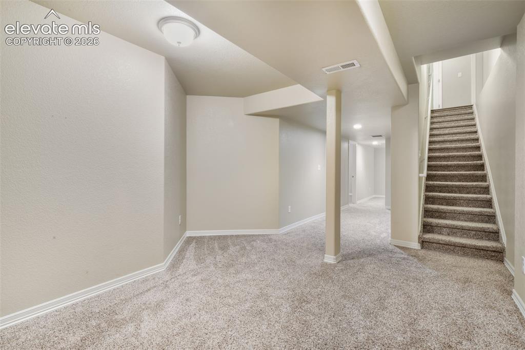 Image 41 of 50: Lower level with recessed lighting, neutral carpet, and painted walls