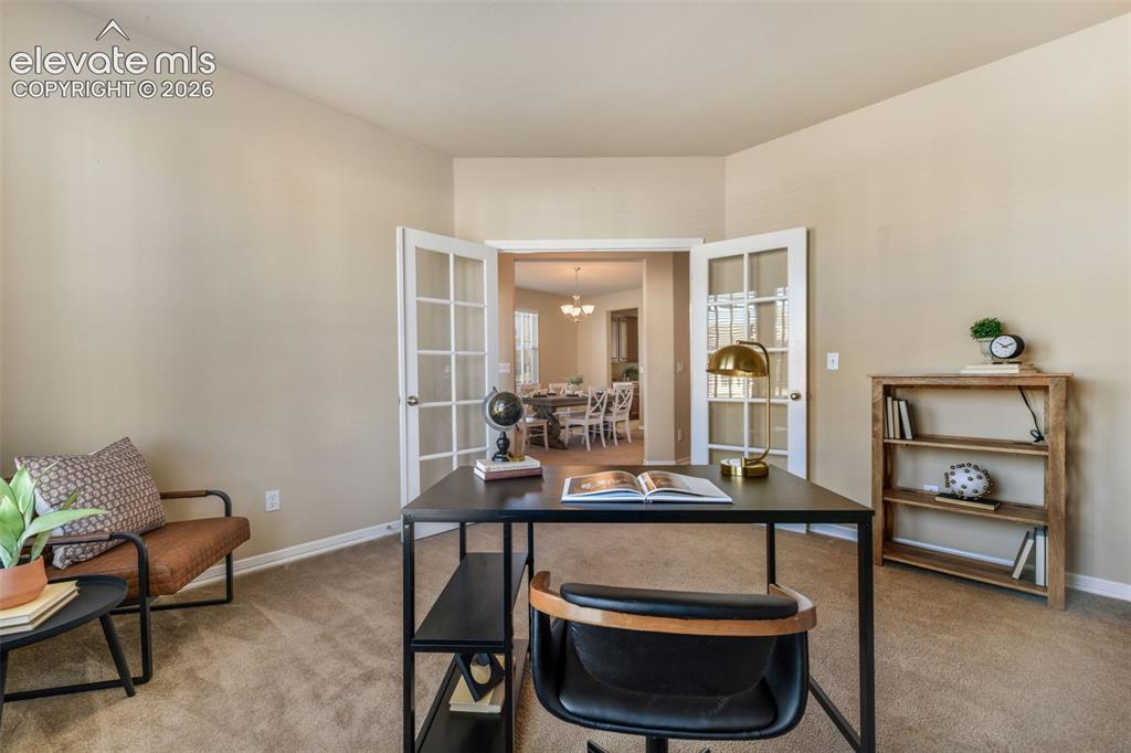 Image 7 of 50: Carpeted room with a vaulted ceiling