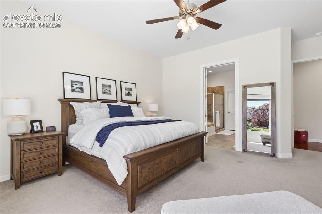 Image 20 of 50: Carpeted flooring, ceiling fan, neutral wall tones, hardwood furniture, and