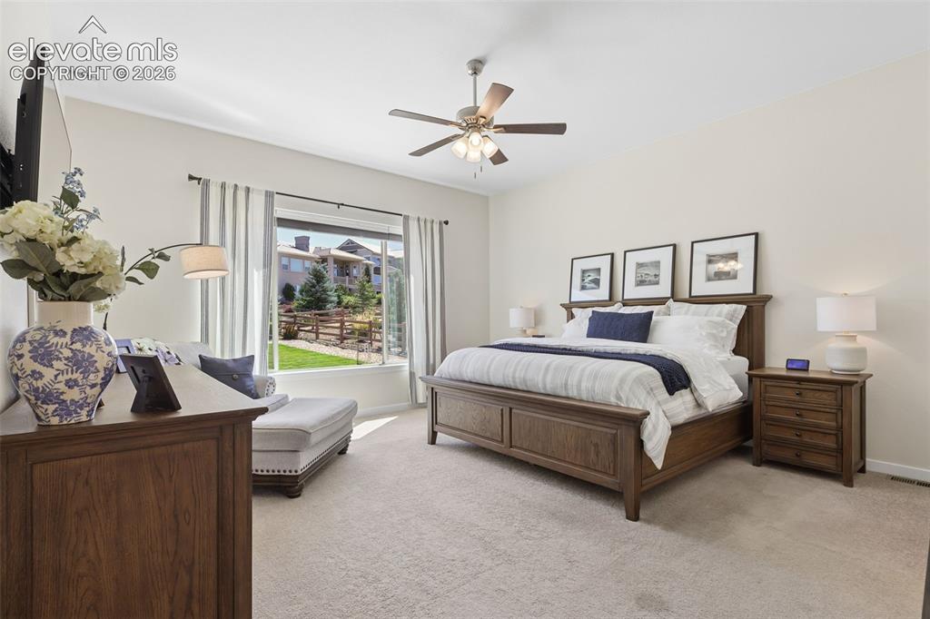 Image 22 of 50: Carpeted flooring featuring a ceiling fan, a large window, light-toned wall
