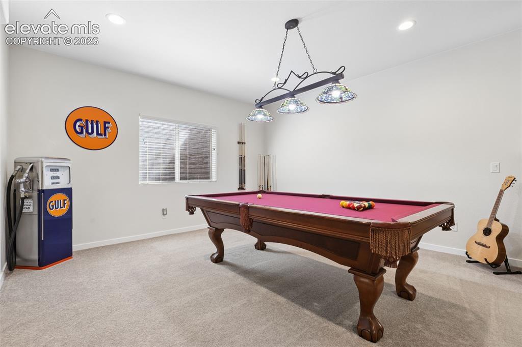 Image 36 of 50: Recessed ceiling lighting, a window with blinds, and a chandelier with deco