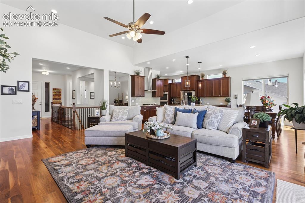 Image 9 of 50: Vaulted ceiling with a ceiling fan, recessed lighting, wood-finish flooring