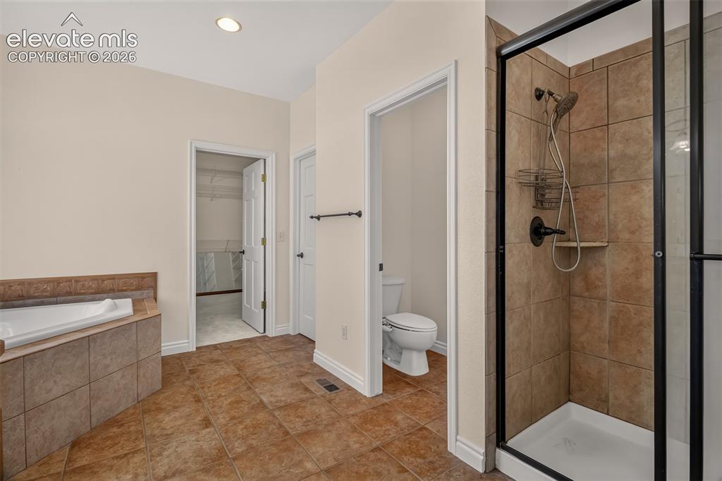Image 29 of 50: Spacious Bathroom With Soaking Tub And Free Standing Shower