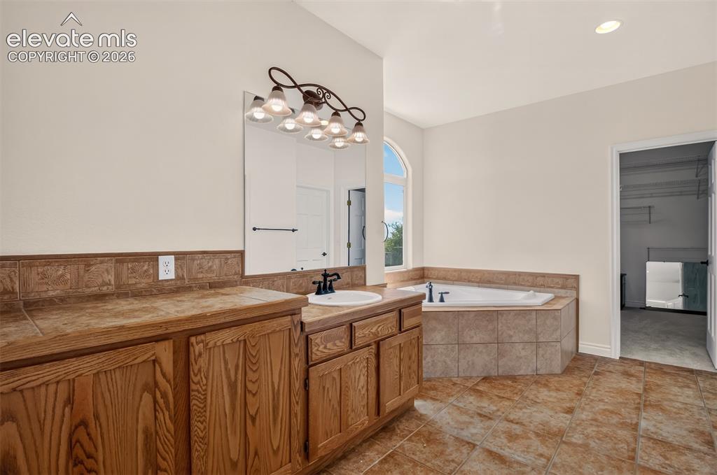 Image 30 of 50: Large Walk-In Closet, Tile Floor And Counters
