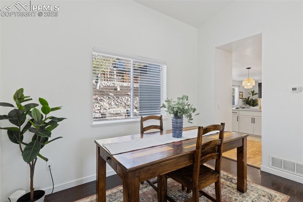 Image 10 of 36: Dining space featuring dark wood-style floors