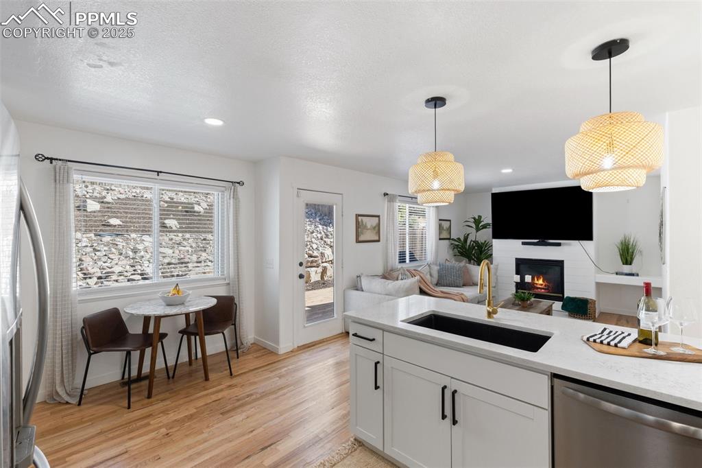 Image 11 of 36: Kitchen featuring appliances with stainless steel finishes, light wood-styl