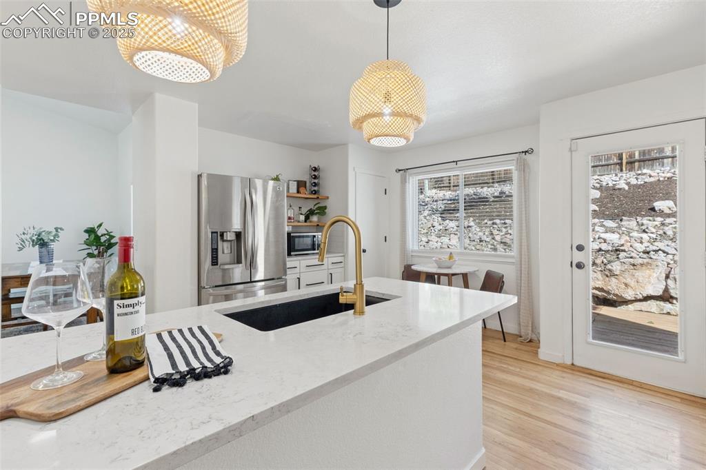 Image 14 of 36: Kitchen featuring appliances with stainless steel finishes, pendant lightin