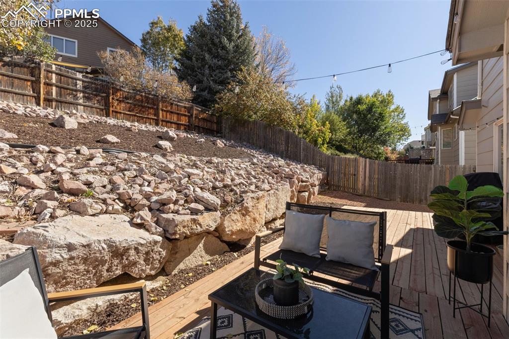 Image 29 of 36: Deck with a fenced backyard and an outdoor hangout area