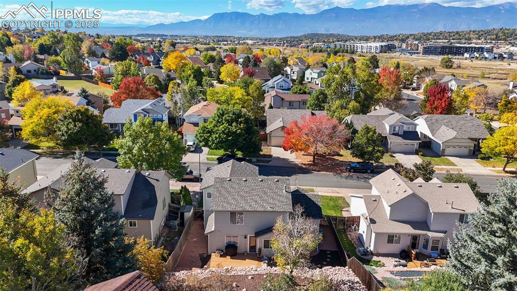 Image 5 of 36: Aerial view of residential area featuring mountains