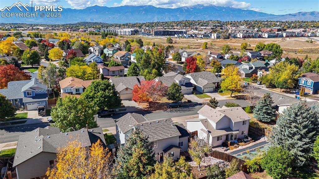 Image 6 of 36: Aerial perspective of suburban area featuring a mountainous background
