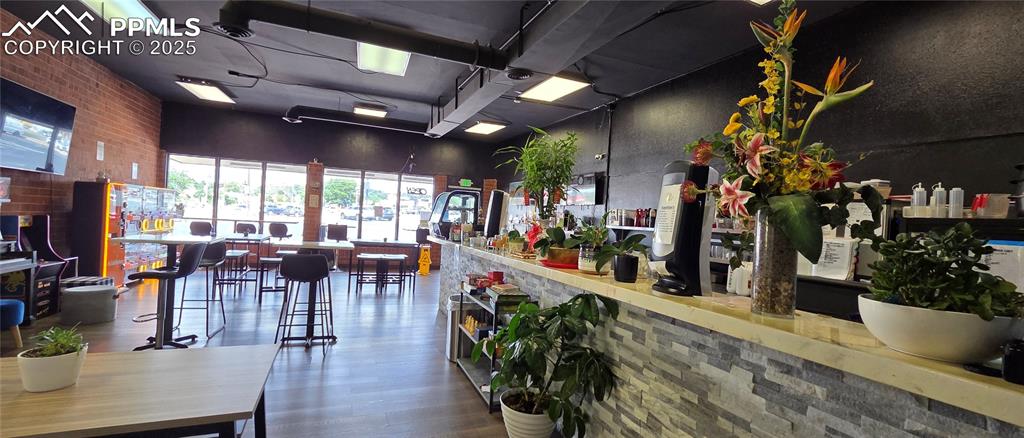 Caption: Reception area featuring brick wall