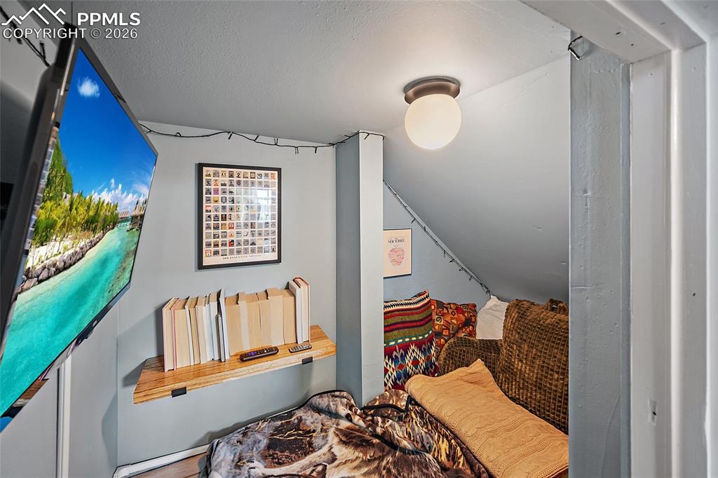 Image 31 of 42: Custom under-stair alcove transforms often-wasted space into an inviting en