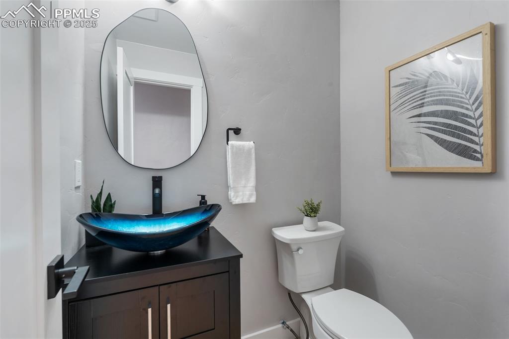 Image 15 of 48: Half bathroom with toilet and vanity