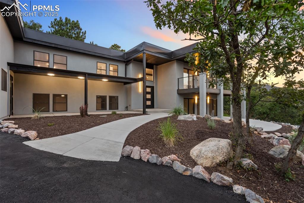 Image 2 of 48: View of front facade with a balcony and stucco siding