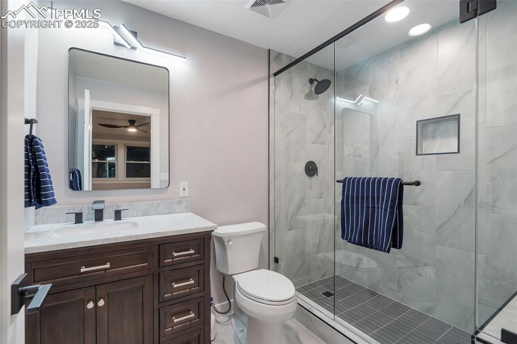 Image 28 of 48: Full bathroom with vanity, a shower stall, and recessed lighting
