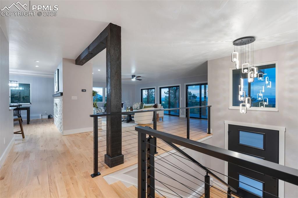 Image 3 of 48: Corridor featuring light wood-type flooring, an upstairs landing, and reces
