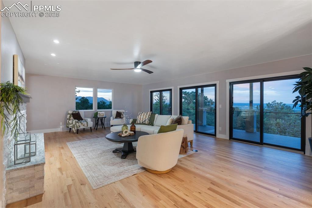 Image 4 of 48: Living room featuring wood-type flooring and ceiling fan
