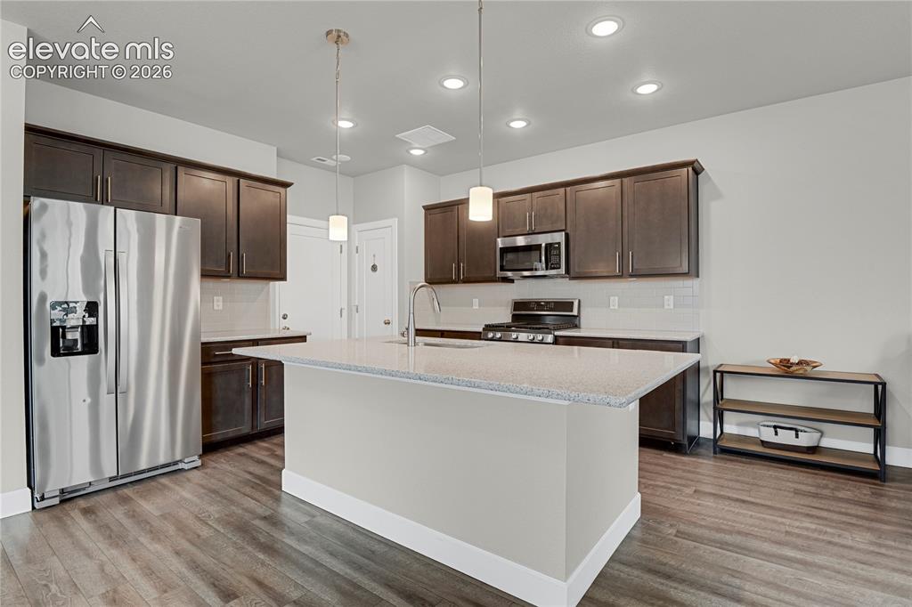 Image 6 of 28: Spacious kitchen with center island, quartz counters, upgraded cabinetry an