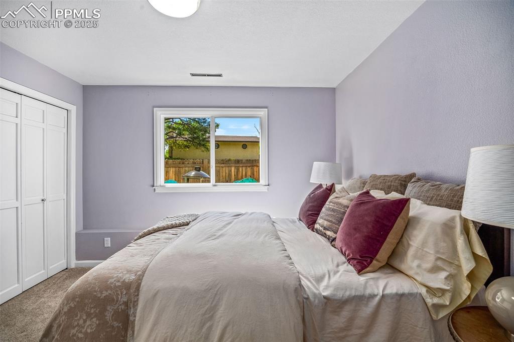 Image 22 of 47: Carpeted bedroom with a closet and baseboards