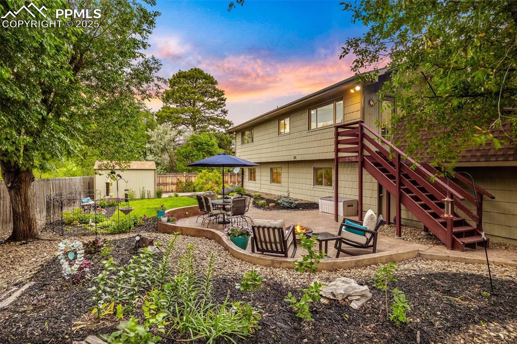 Image 3 of 47: Rear view of house featuring a shed, a patio area, a fenced backyard, and s