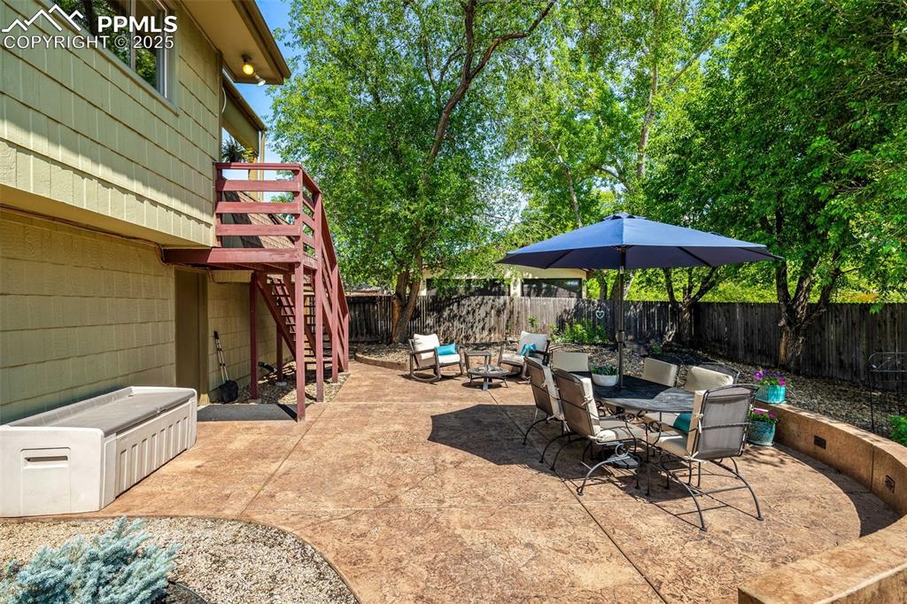 Image 33 of 47: Fenced backyard with stairway, a patio area, a deck, and outdoor dining are