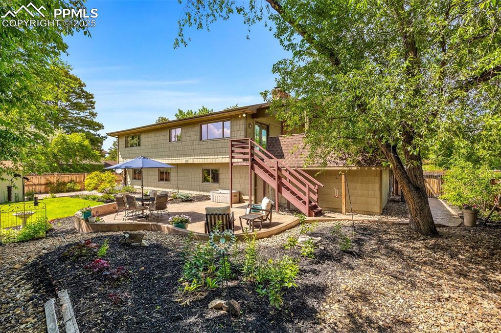 Image 39 of 47: Back of property with a fenced backyard, a patio, and stairs