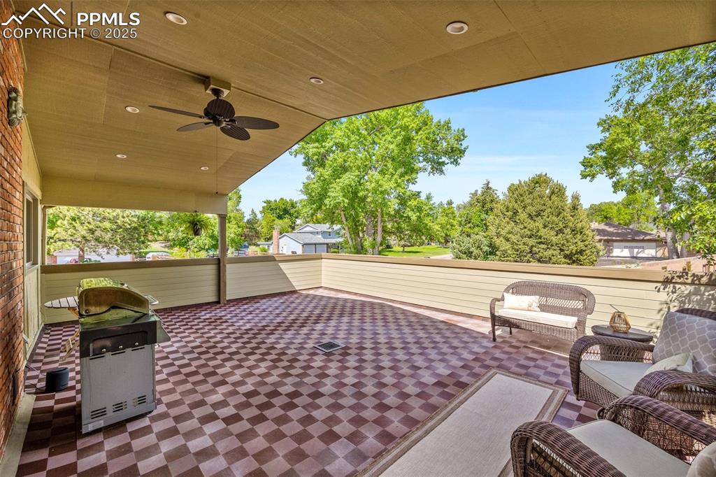 Image 40 of 47: View of patio with a ceiling fan and area for grilling