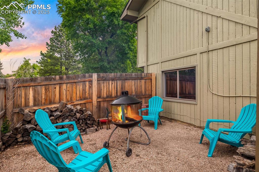 Image 42 of 47: Patio terrace at dusk with a fire pit