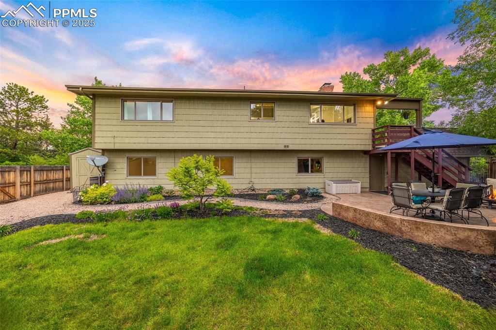 Image 44 of 47: Rear view of house featuring a patio, a chimney, a fenced backyard, stairwa