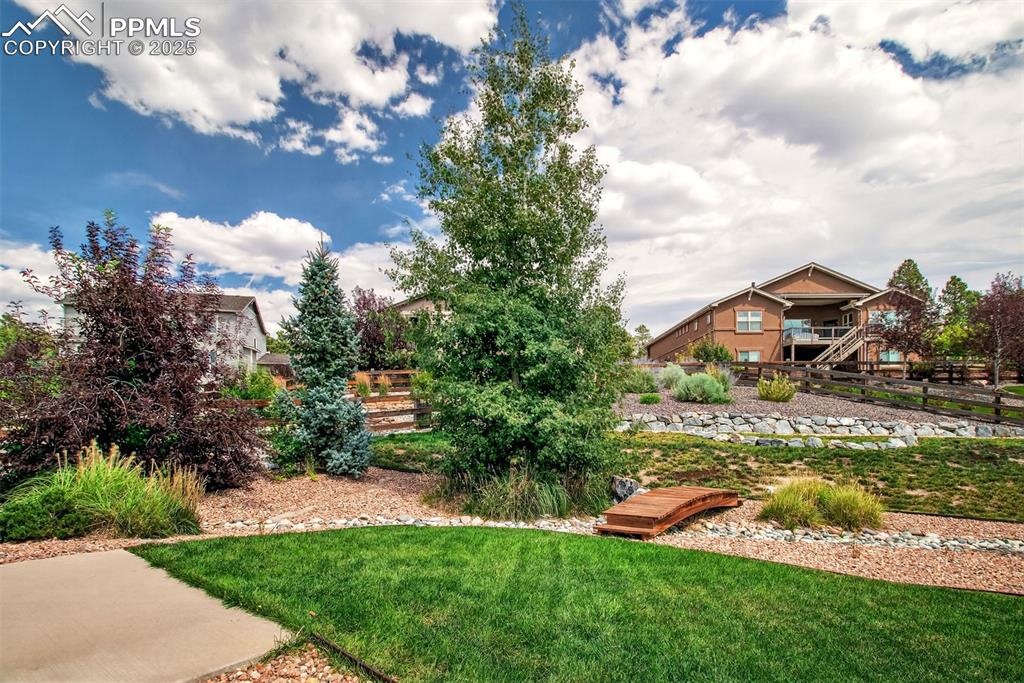 Image 28 of 48: Large and beautifully landscaped yard. 